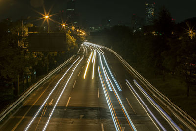 High angle view of light trails on road at night