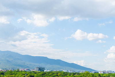 Scenic view of buildings and mountains against sky