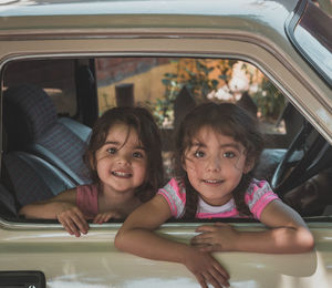 Portrait of smiling girl sitting in car