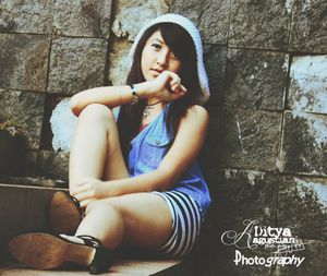 Portrait of young woman sitting outdoors