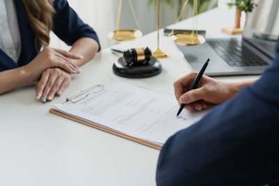 Midsection of man working at desk in office