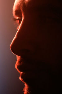 Close-up of young woman over black background