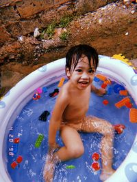 Portrait of shirtless boy in water