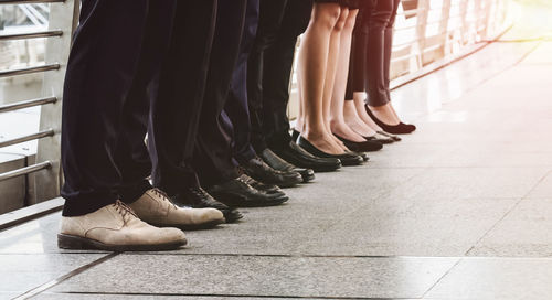 Low section of people standing on walkway