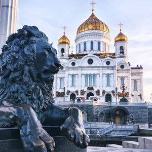 Lion statue by cathedral of christ the saviour against sky