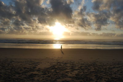 Scenic view of beach against sky during sunset