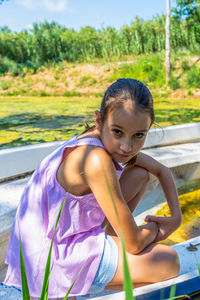 Portrait of girl sitting on steps in park