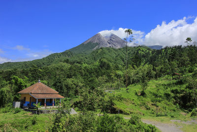 Scenic view of landscape and mountains against blue sky