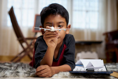 Portrait of boy sitting on table