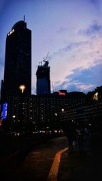 Illuminated buildings against sky at night