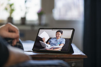 Man having online doctor consultation on digital tablet
