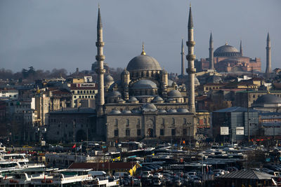 View of mosque in city against sky