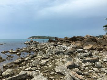 Rocks on beach against sky