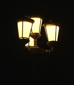 Low angle view of lamp post at night