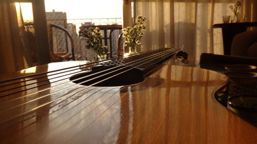 Close-up of guitar on table at home