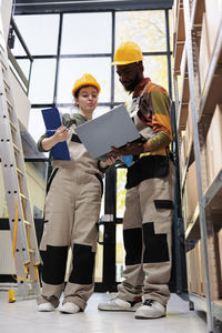 Low angle view of man using digital tablet