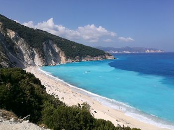 Scenic view of beach against blue sky