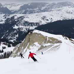 People skiing on snowcapped mountain