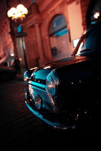 Close-up of vintage car on illuminated street
