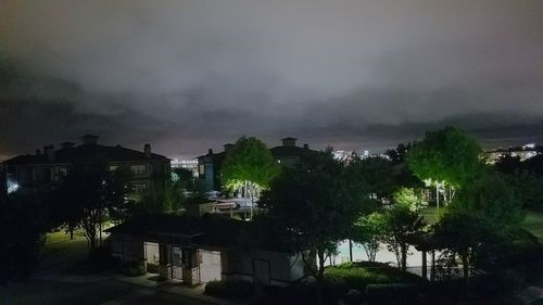 High angle view of buildings against sky at night