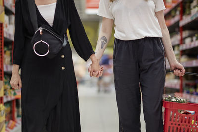 Mid section of couple doing shopping in supermarket