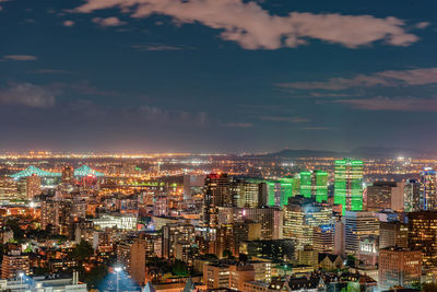 High angle view of illuminated buildings against sky at night