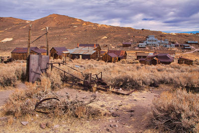 Houses on field against sky