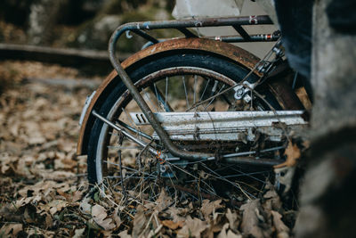 Close-up of abandoned bicycle on field