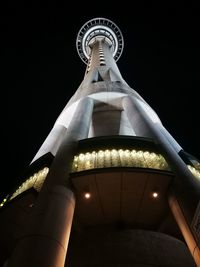 Low angle view of illuminated building against sky at night