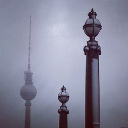 Low angle view of communications tower against sky