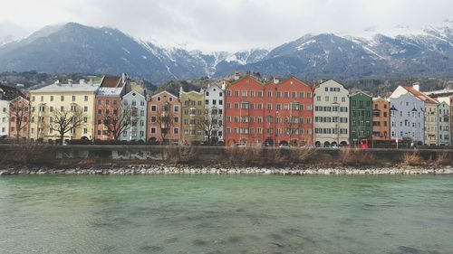 Town by river with mountains in background