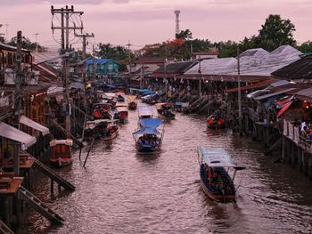 High angle view of boats in river against buildings