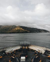 High angle view of cruise ship sailing on sea against cloudy sky