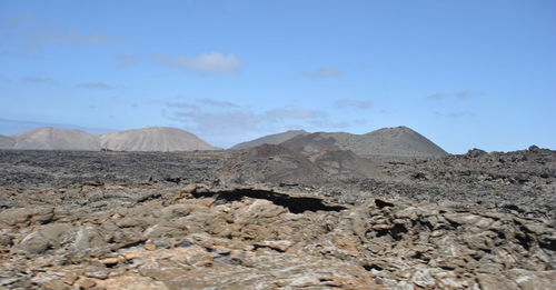 Scenic view of arid landscape against sky