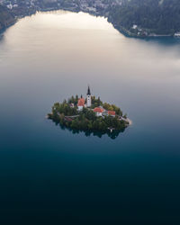Aerial view of cerkev marijinega, a catholic church on a small island in the middle of bled lake 