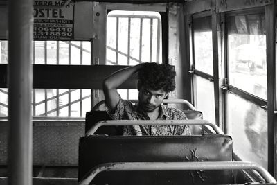 Rear view of woman sitting in bus