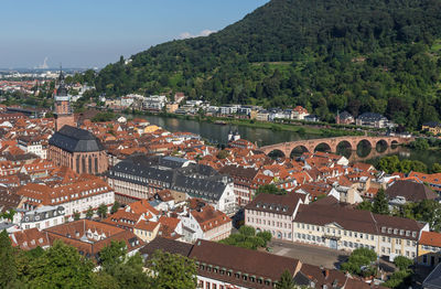 High angle view of townscape by river in city