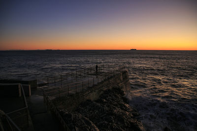 Scenic view of sea against clear sky during sunset