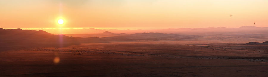 Scenic view of landscape against sky during sunset