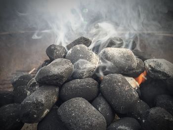 Close-up of smoke emitting from charcoals