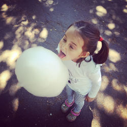 Little girl playing with arms raised