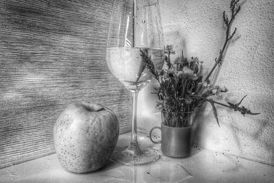 Potted plant on table against wall