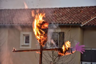 Burning candles on roof of building