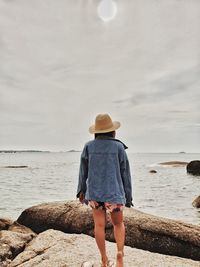 Rear view of woman looking at sea against sky