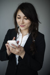 Young businesswoman using smartphone