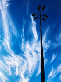 Low angle view of street light against blue sky