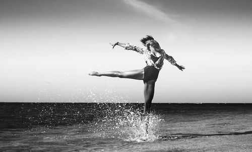 Woman jumping in sea