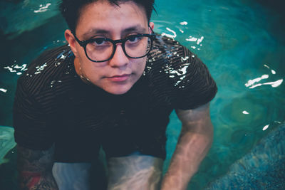 Portrait of young man swimming in pool