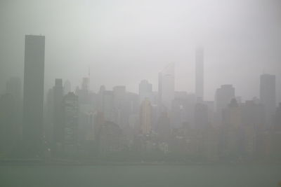 View of skyscrapers in foggy weather