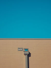 Low angle view of building against clear blue sky